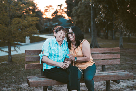 Women laughing on a bench